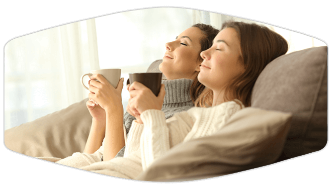 Women relaxing on the couch with coffee