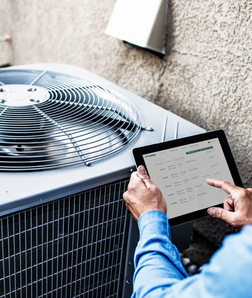 tech using tablet to check ac unit